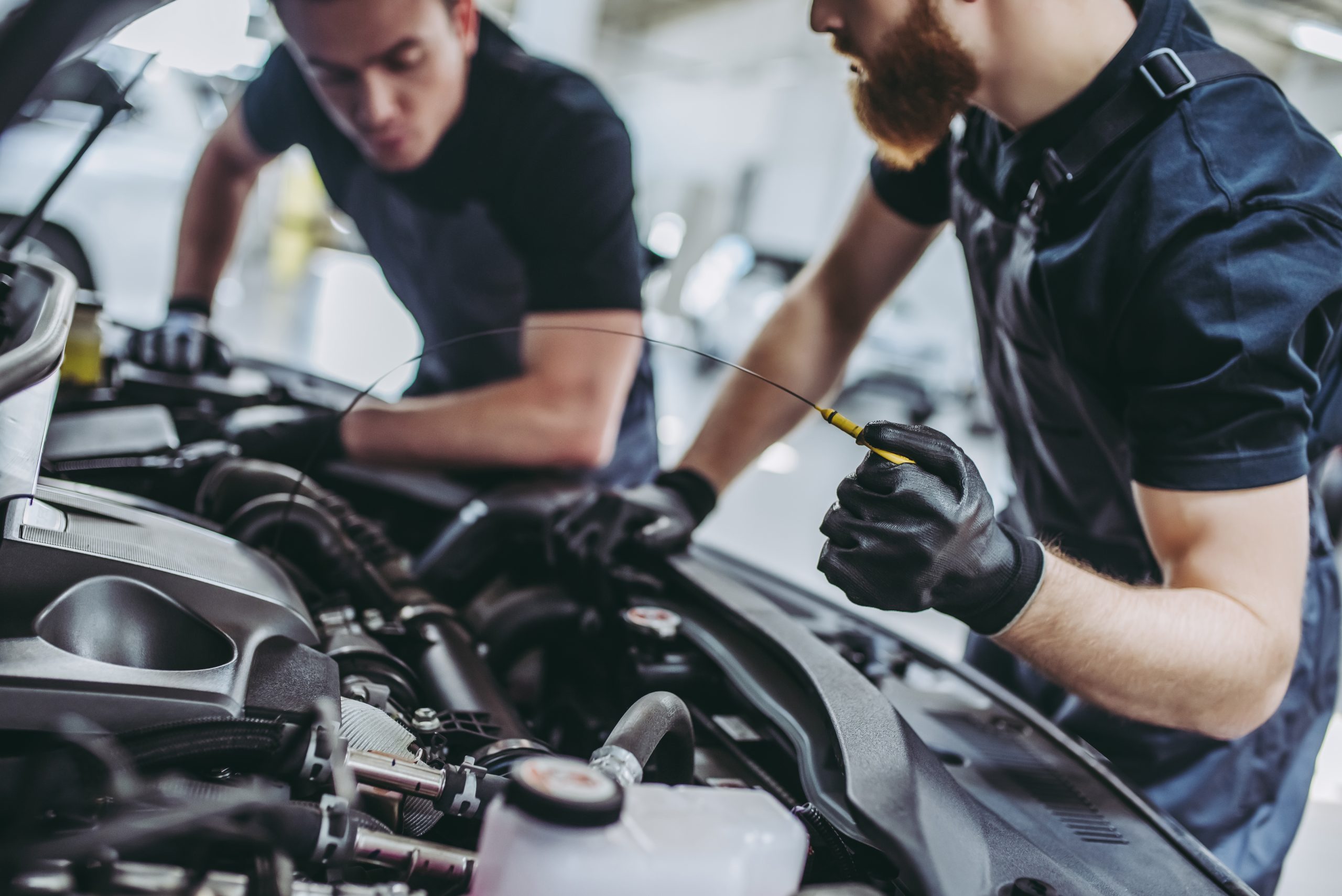 Technicians performing routine maintenance on an engine