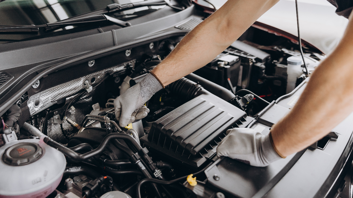 Technician checking the oil in a CDJR engine