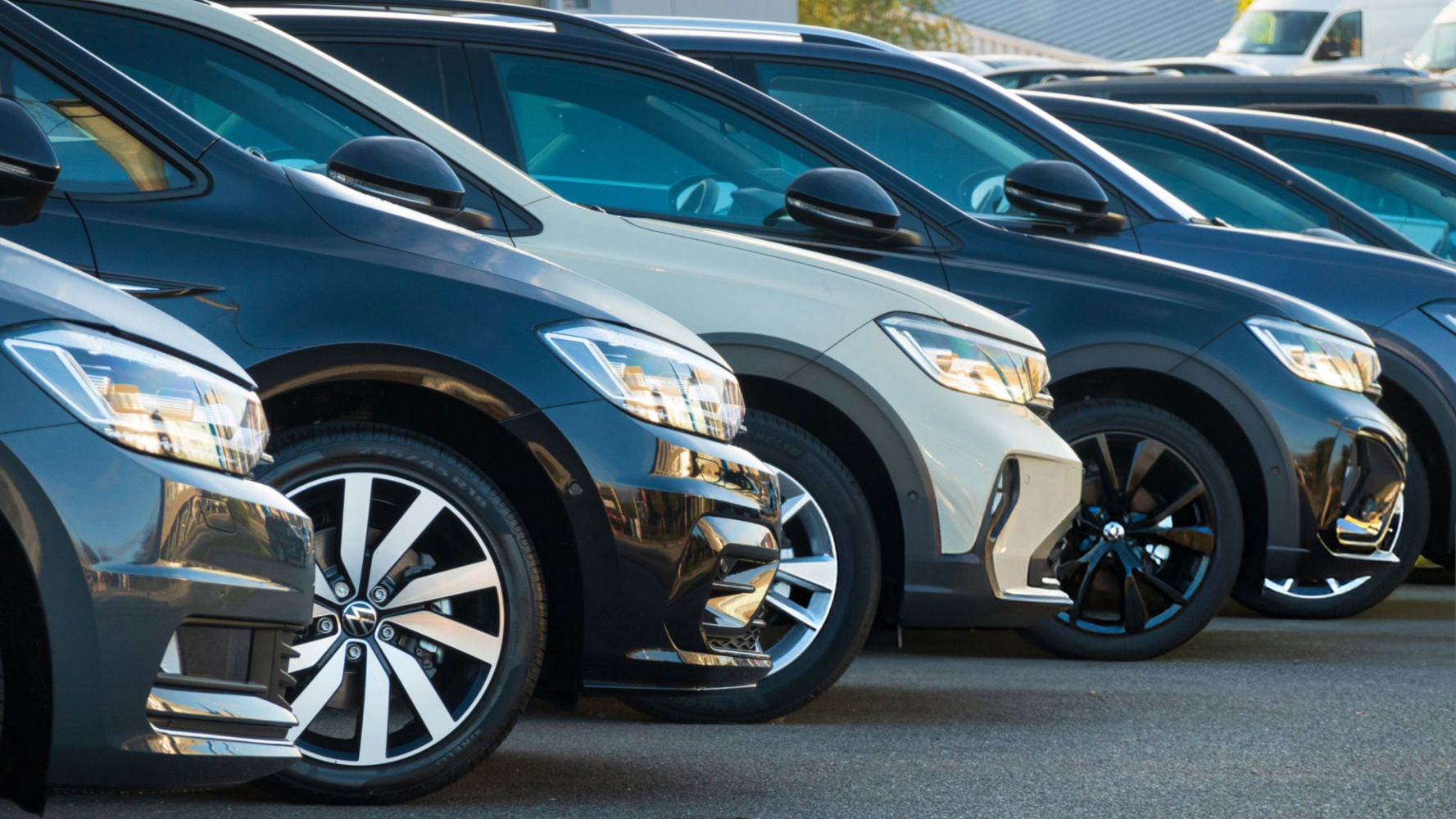 A row of used cars on a dealership lot.