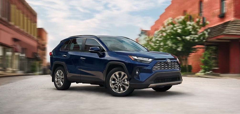Blue 2025 Toyota RAV4 parked on an urban street