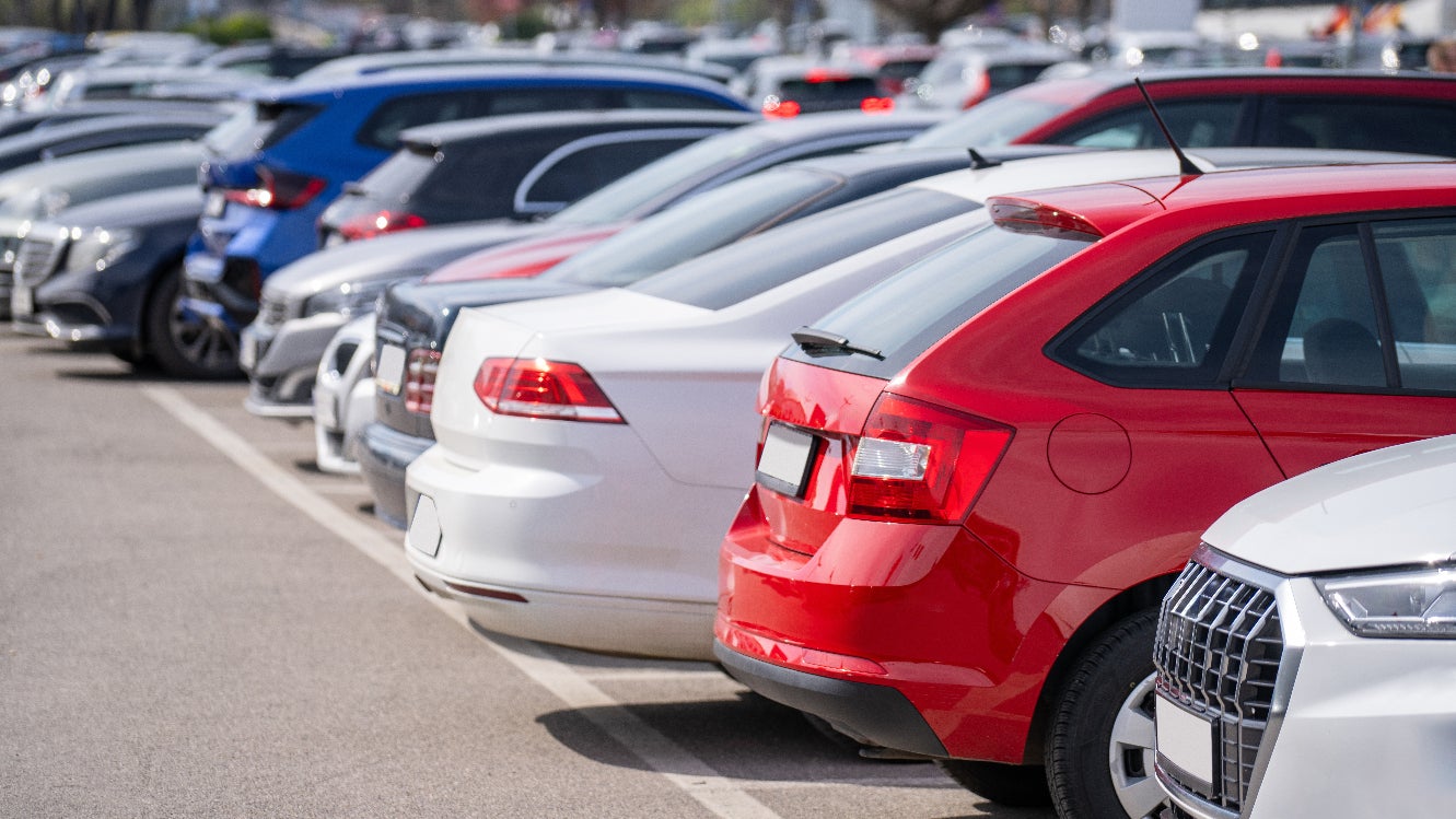 A row of cars in a parking lot.